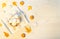 Autumn composition with a cup of meringues, yellow leaves, walnuts on a white wooden background