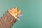 Autumn composition with golden leaves in gift bag on green paper background. Fall mockup with gold maple leaves. Flat lay, top