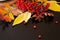 Autumn composition of leaves, rowan berries and candles