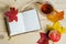 Autumn composition, open diary, colorful leaves, apple fruit, hot drink tea on a light wooden background. Thanksgiving Day.