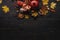 Autumn composition. Pomegranate with nuts, spices and dry leaves on a dark wooden table. Top view. Copy space