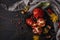 Autumn composition. Pomegranate with nuts, spices and dry leaves on a dark wooden table. Top view. Copy space