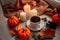 Autumn composition presented by pumpkins, candles, cup of coffee