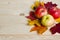 Autumn composition, ripe juicy apples and fallen leaves on a light wooden background. harvest, thanksgiving.