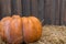 Autumn composition with ripe pumpkins, straw on a background of wood.Thanksgiving holiday concept. Autumn harvest, fall