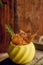 Autumn composition with small red apples, dried pomegranate in vintage planter, branches of larch in clay pot, vase on metal plate