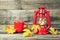 Autumn composition with vintage oil lamp, coffee cup and autumn leaves