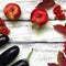 Autumn composition on a wooden background. Apples, viburnum, eggplant, leaves and flowers