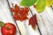 Autumn composition on a wooden background. Apples, viburnum and leaves