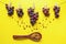 Autumn concept. Bunches of grapes pinned on rope, raisins in wooden spoon. Copy space