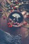 Autumn concept. Cup of herbal tea with red fall berries decorated with leaves on dark rustic wooden table background