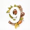 Autumn concept. Number nine shape with autumn leaves, acorns and fearhers. Nature concept. Flat lay. Top view