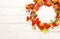 Autumn concept with pumpkins, flowers, autumn leaves and  rowan berries on a white rustic background. Festive autumn decor, flat