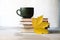 Autumn concept stack of books, coffe cup and maple leaves