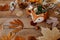 Autumn creative composition made of pumpkins, tea cup, dried leaves.