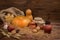 Autumn dark Thanksgiving still life with pumpkins, red apple, ga