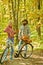 Autumn date hike in forest. Couple in love ride bicycle together in forest park. Romantic date with bicycle. Bearded man