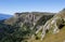 autumn day in the forest, mountainous terrain with dried vegetation, panorama of the area