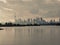 Autumn day view across inner bays of Lake Ontario in Tommy Thompson Park with foggy Downtown Toronto skyline under grey
