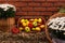 Autumn decor with vegetables and flowers on dry haystacks. Harvest and garden outdoor decorations for Halloween, Thanksgiving,