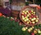 Autumn decoration, wooden barrel, red and green apples in a wicker basket on straw, pumpkins, squash, heather flowers