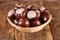 Autumn Delights: Raw Chestnuts in a Charming Retro Basket