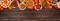 Autumn desserts top border with various traditional fall treats, top view on a wood banner background