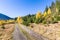 Autumn dirt road in mountains