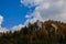 Autumn dramatic landscape mountain rocks peaks above moody brown foliage of forest trees top October day time nature photo