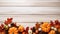 Autumn Elegance: Pumpkins and Pine Cones on Whitewash