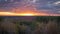 Autumn evening over the valley. Beautiful view to the multicolored forest and orange october sunset