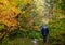 Autumn fairy with senior walking in forest