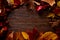 Autumn fall frame golden red leaves on wood