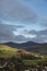 Autumn Fall landscape view from Loughrigg Brow over Keswick towards mountain background with dramatic sky