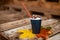 Autumn, fall leaves, hot steaming cup of coffee on a wooden table background