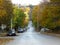 Autumn fall in the town city. Colourful red and yellow trees in the street.