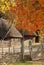 Autumn, fall village. Park in Ukraine. image of an old house with a straw on the roof. Around the house is a wicker fence