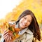 Autumn / Fall woman holding colorful leaves