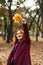 Autumn fashion, earth tones style, bright fall color palette. Portrait of red-haired girl in purple coat