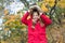 Autumn fashion. Feeling protected at autumn day. Happy little girl in autumn forest. Small child with autumn leaf. Happy