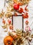 Autumn flat lay blank white letter board on white blanket decorated with fall arrangement: leaves, pumpkins, rowan ,burning