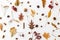 Autumn flat lay. Fall leaves, berries, acorns, walnuts, cinnamon and anise on white background. Minimalistic autumn natural
