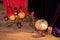 Autumn floral bouquet in a copper vase on a wooden floor decorated with pumpkins for Halloween candles. Table setting