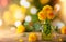 Autumn floral bouquet made of fresh yellow dahlia in green vase on blurred green background with festive bokeh