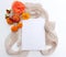 Autumn floral still life composition. Close up blank greeting card mock-up scene. Orange flowers on white table background and