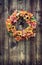 Autumn flower wreath against wood planks