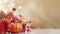 autumn flowers and pumpkins on a table, set against a softly lit, blurred background