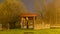 Autumn fog landscape from the park, illuminated trees and buildings in the dark, long exposure, blurred mystical picture