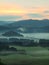 Autumn fogy countryside. View into long foggy valley full of colorful mist. Autumn melancholic landscape