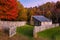 Autumn foliage and rustic cabin in sunset glow